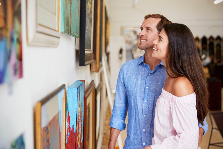 couples looking at different artworks in a museum